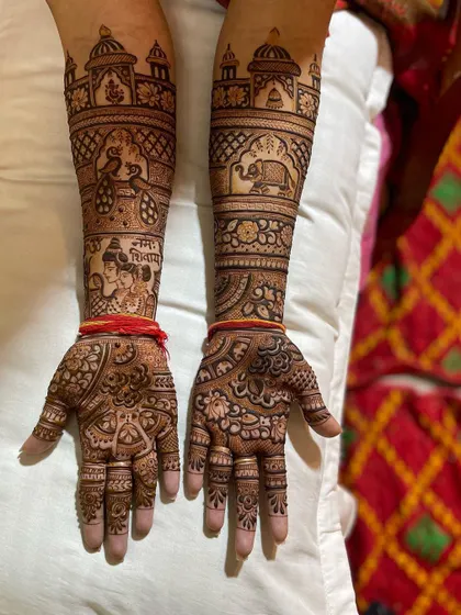 This full-arm design includes a beautiful portrait of Shiv and Parvati on the forearm, along with traditional Rajasthani elements like palaces and elephants.