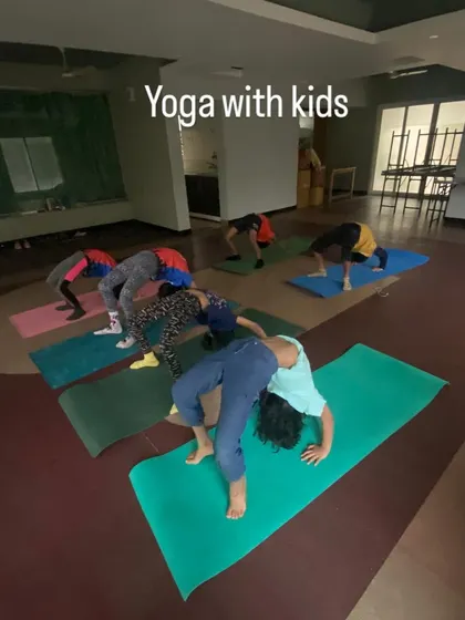 Here you can see a group of kids practicing their wheel pose. I ensure each child works at their own level, providing support and encouragement to help them safely explore what their bodies can do.