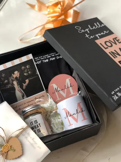 "Love in a Box" for Valentine's Day. This romantic hamper includes a personalized mug and coaster, a custom photo, and other sweet treats to surprise your partner.