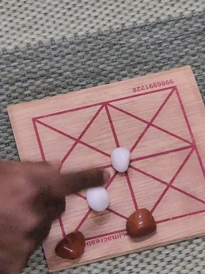 A close-up of one of the traditional board games played during our workshop. These games, which seem simple, require strategic planning and are a great way to build logical reasoning skills.
