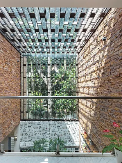 Looking down into the courtyard from an upper floor, you can see the intricate shadow patterns created by the MS grill skylight. This detail adds a dynamic layer of visual interest to the space throughout the day.