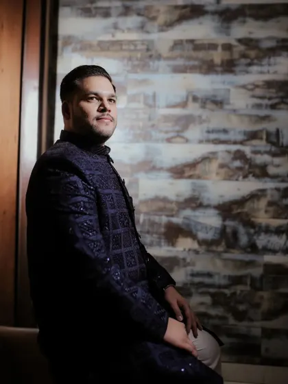 A handsome portrait of the groom-to-be, looking thoughtful and poised before his engagement ceremony.