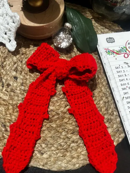 The finished red bow hair tie, perfect for the festive season or any day you want to feel a little extra special.