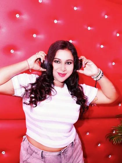 A casual and cool shot against a red, textured wall. This look is relaxed but still ready to get behind the decks and feel the music.