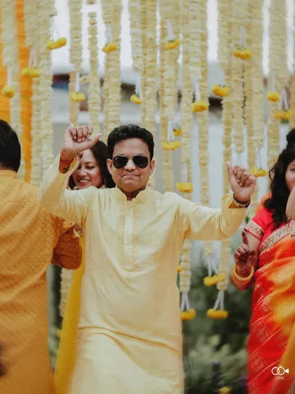 A family member enjoying the music and dancing at the Haldi, captured in a moment of pure celebration.