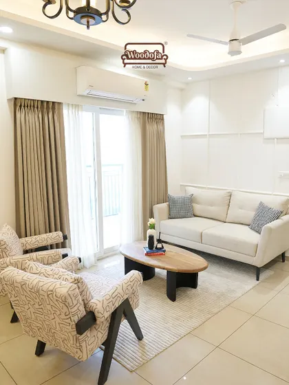 A simple and elegant living room setup. The neutral sofa and armchairs create a calm base, while the patterned upholstery on the chairs adds a touch of personality. This design shows that you don't need a lot to create a beautiful and functional space.