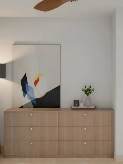 A simple and modern wooden chest of drawers serves as a functional piece in this entryway. Paired with a floor lamp and abstract art, it creates a clean and contemporary welcome.