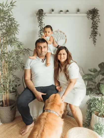 Another take on the family portrait, showing the playful interaction with their golden retriever.