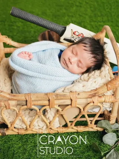Swaddled and sleeping soundly in a basket, this little cricketer is resting up for the big game.