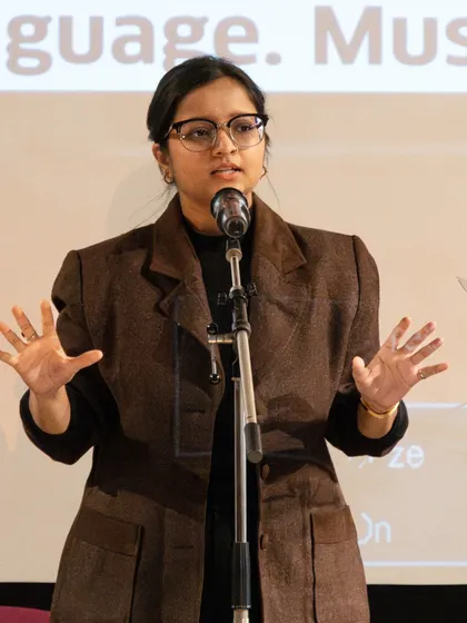 A poet using expressive hand gestures to bring her spoken word piece to life. Our performance coaching covers both verbal and non-verbal communication skills.