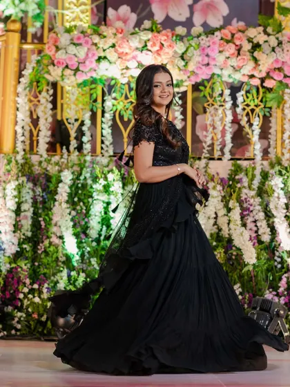 The full look against a floral backdrop. The makeup is designed to be picture-perfect from every angle.