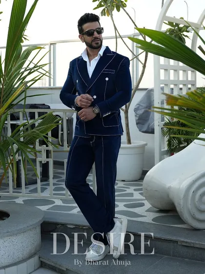 The blue velvet suit in a relaxed, full-length pose. This ensemble proves that luxury can be both comfortable and incredibly stylish.