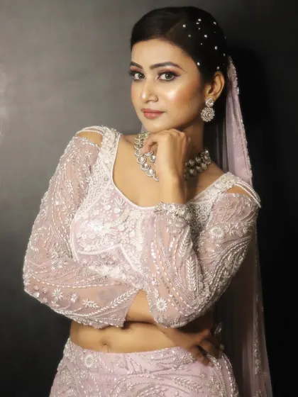 A confident pose from our model, showcasing the full effect of the angelic lavender look. The makeup is designed to look stunning from every angle.