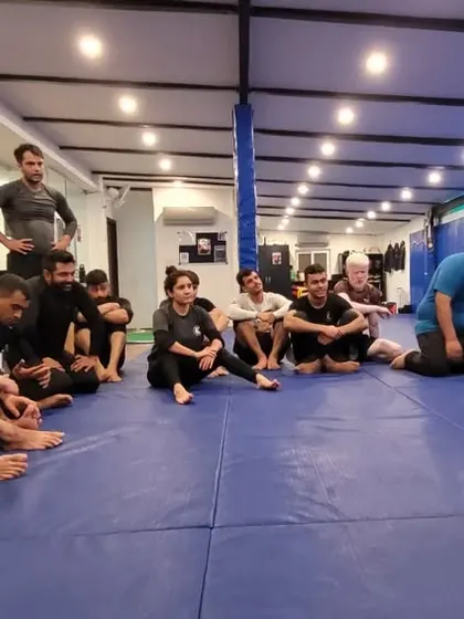 A moment of instruction during the triangle choke deep dive. Understanding the small adjustments is what makes a good submission a great one.