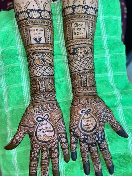 A fun and creative take on baby shower mehandi. This design includes playful elements like 'Baby Loading', 'Boy or Girl?', and tiny baby clothes, making it a memorable part of the celebration.