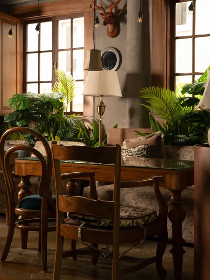 This view showcases the layered luxury of Echoes. The mix of textures, from the soft upholstery to the wooden window frames and lush plants, creates a rich sensory experience that invites guests to relax and connect.