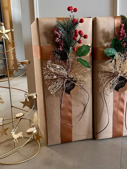 For a more rustic and natural look, I love using brown craft paper paired with earthy ribbons and botanical sprigs. These gifts are ready for Christmas delivery, showing how different materials can create a warm, festive feel.