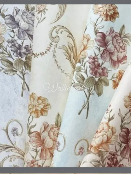 A close-up of several floral damask wallpaper rolls in different color schemes.