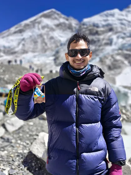 A proud trekker with his completion medal at EBC. The sense of accomplishment after reaching this world-famous destination is an experience that stays with you forever.