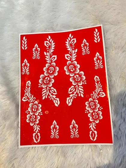 This red stencil sheet shows the design more clearly. It features two long floral vines with accompanying smaller leaf motifs for customization.