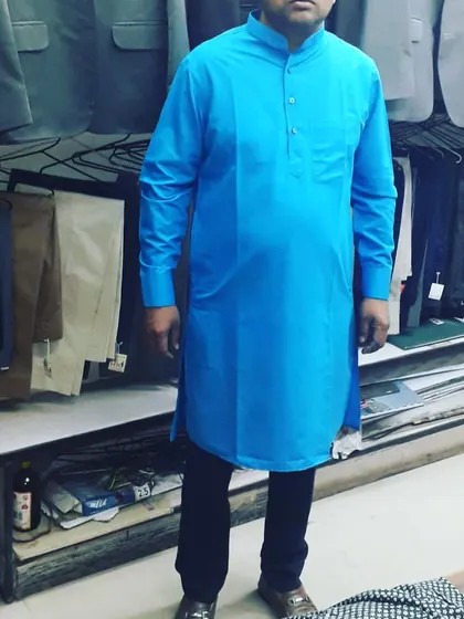 A client wearing a bright blue kurta tailored by me. The fit is comfortable yet structured, suitable for all-day wear.
