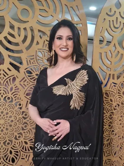 A full view of this elegant glam look. The makeup is designed to complement the black saree, creating a cohesive and head-turning appearance.