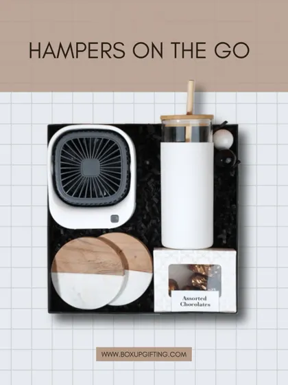 Hampers on the go. This hamper includes a mini desk fan, a sipper, assorted chocolates, and marble coasters, showing how we combine practical tech with lifestyle treats.