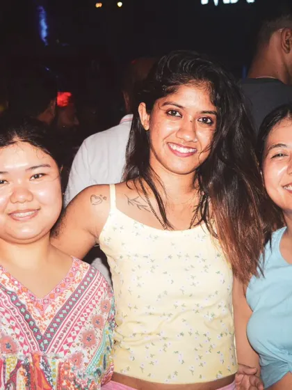 Friends smiling and posing for a photo on the dance floor. I provide the soundtrack for great memories and fun nights out.