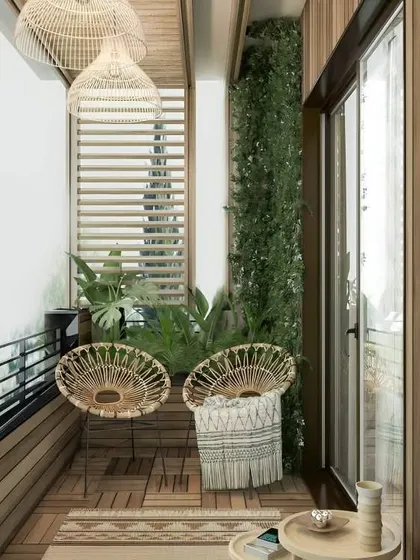 Perfect for narrow balconies, this setup uses two stylish rattan chairs to create an intimate seating nook. The wooden slats and flooring create a warm, cohesive look, while a living wall adds a splash of green.