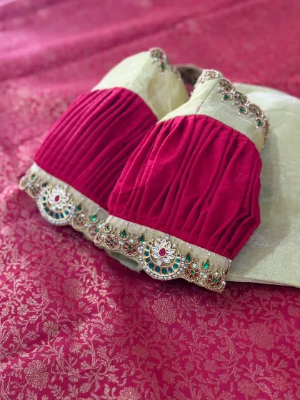 A unique blouse with pleated velvet sleeves and an embroidered cuff.