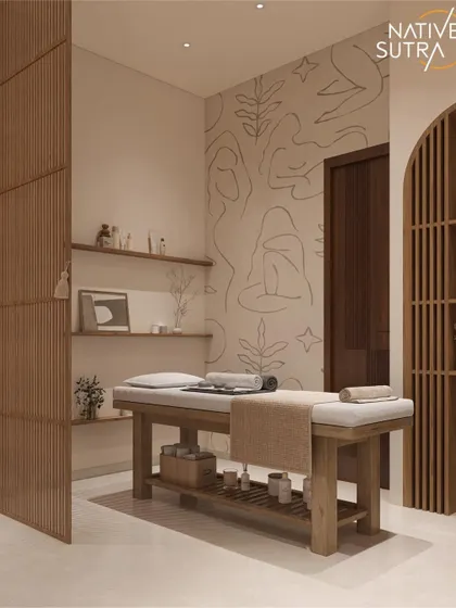 The massage area within the private home spa. A simple wooden massage table, slatted wood partitions, and a wall with custom line art create a professional and deeply calming environment for wellness at home.