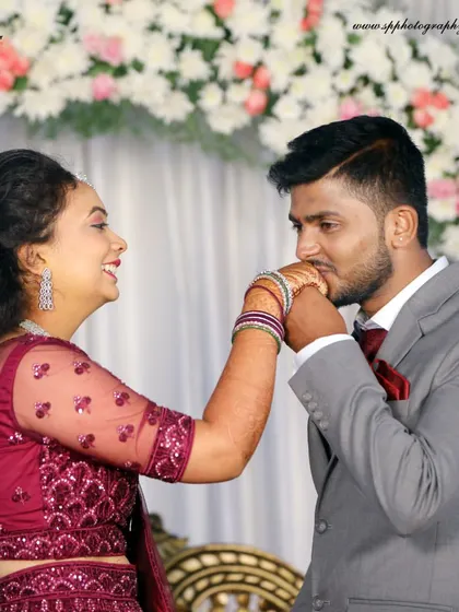 A playful and romantic moment from a reception. The groom kissing the bride's hand is a classic gesture of love that we capture with a candid feel.