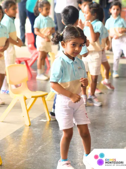 A young athlete stands ready for her event, her focused expression showing her dedication.
