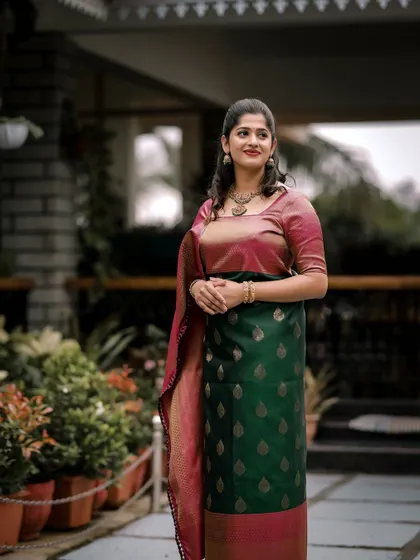An elegant and understated look for a wedding guest. The makeup is soft and natural, enhancing her features without overpowering her beautiful dual-toned saree.