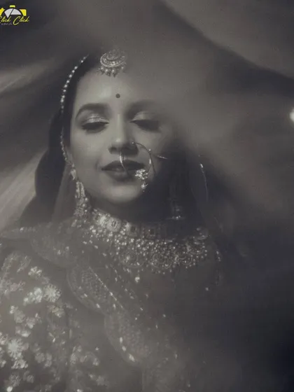 An artistic black and white portrait of the bride. The soft focus and dreamy light flares create an elegant and timeless image that feels like a memory.