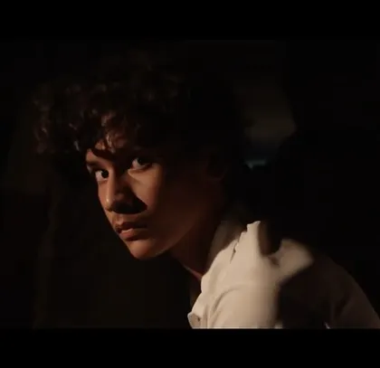 A close-up of a young character in the Air India commercial, his face filled with awe and wonder. The simple styling keeps the focus on the powerful, emotional narrative.