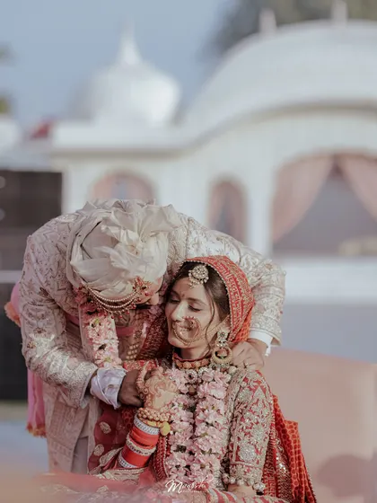 A tender moment post-ceremony, the groom's gentle touch conveying love and care for his new bride.