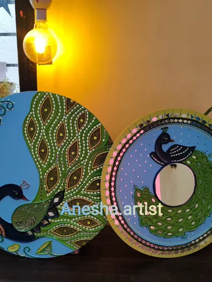 Another view of the peacock themed Lippan art wall hanging and mirror.