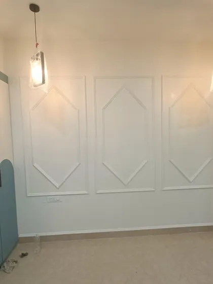 We use wall molding and pendant lights to add a layer of sophistication to bedrooms. This simple yet elegant detail elevates the entire wall and complements the custom furniture.