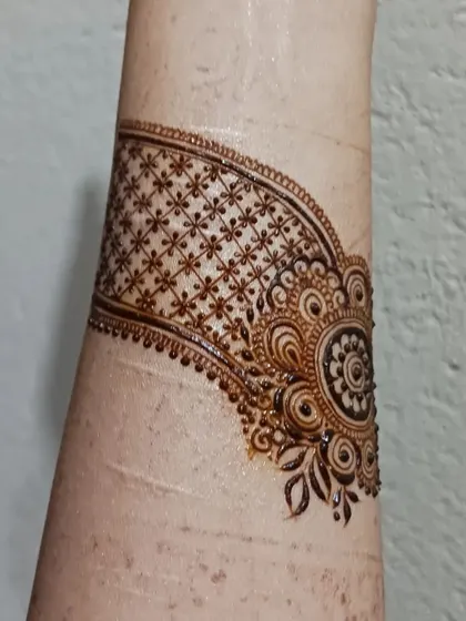 A practice doodle of a cuff design. I often practice creating bands and bracelets with different textures, like this one with a delicate grid and floral motif.
