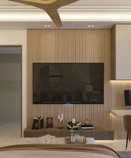 A bedroom concept featuring a functional TV wall with an integrated study desk and open shelving. The use of wood paneling and a neutral color palette creates a warm and modern aesthetic.