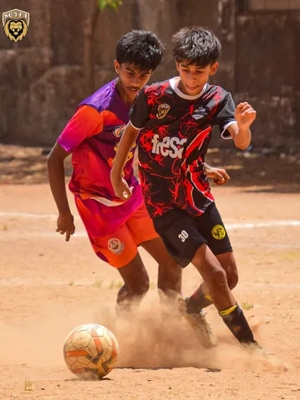 A player demonstrating close control and skill to beat a defender in a one-on-one situation.