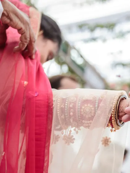 A close-up of the 'Gathbandhan' ritual, where the bride's and groom's garments are tied together. This symbolic act represents their eternal bond, and I capture it with artistic detail.