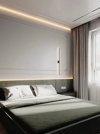 Sleek vertical wall sconces provide a clean, minimalist lighting solution for modern bedrooms. Placed on either side of the bed, they offer excellent reading light while maintaining an uncluttered and sophisticated aesthetic.