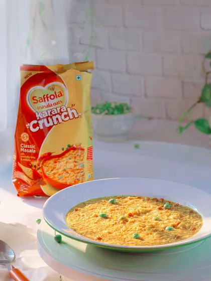 Another take on the Saffola Masala Oats, with soft, natural light creating a gentle and wholesome feel. The focus is on the prepared dish, making it look like a perfect, easy meal.