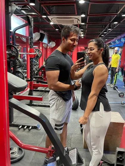 A candid moment at the gym with my partner. We push and motivate each other to be our best.