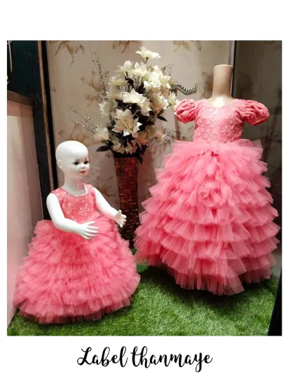 Twinning pink gowns with multi-layered ruffled skirts, displayed in my studio.