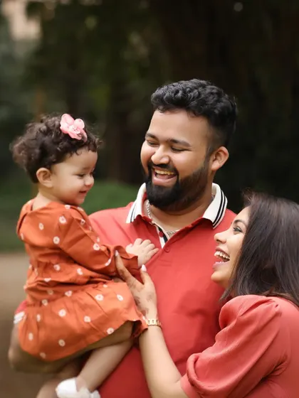 A moment of genuine laughter and connection between parents and their child. Outdoor sessions allow for this kind of spontaneous and natural interaction.