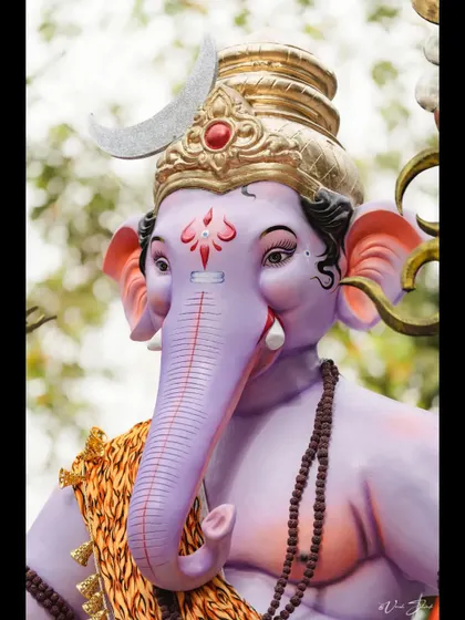 A detailed portrait of the Kopri Cha Samrat, focusing on the calm and serene expression of the idol.