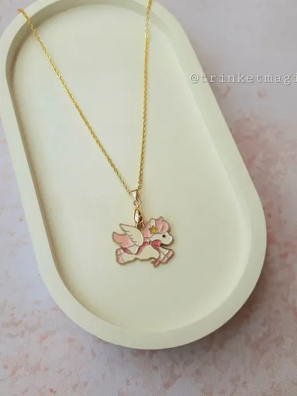 A magical pink winged unicorn (Pegasus) on a simple gold-colored chain. This necklace is perfect for little dreamers.